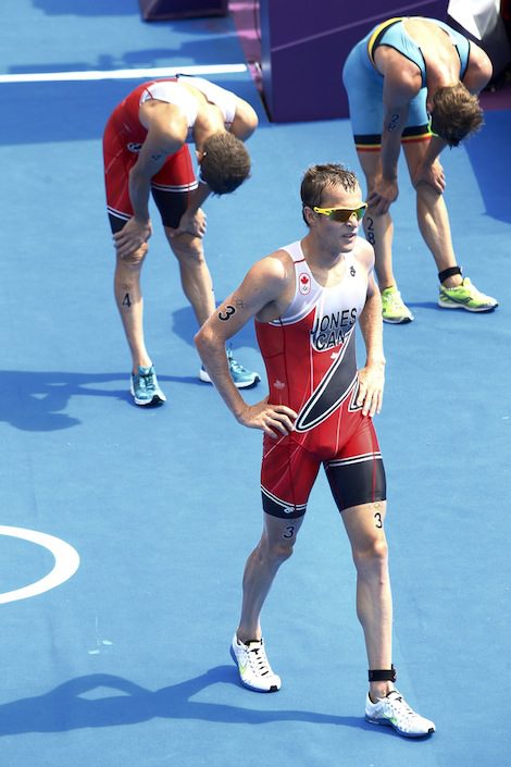 07 AUG 2012 - LONDON, GBR - Kyle Jones (CAN) of Canada (front) walks away from the finish line after the men's London 2012 Olympic Games Triathlon in Hyde Park in London, Great Britain. Copyright (C) 2012 NIGEL FARROW