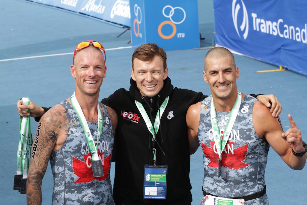 Simon Whitfield greets athletes and presents medals at the finish line. Credit: Jordan Bryden