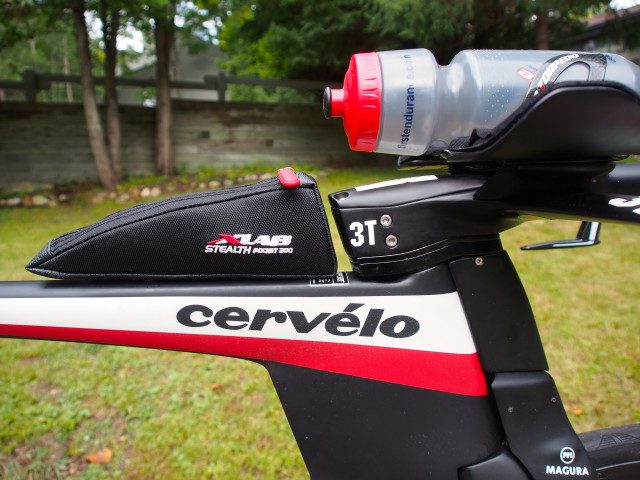 The Cervelo P5 have a set of standard bottle cage mounting bolts on the top tube, which lets a rider attached whatever they might securely. In this case, Heather have a X-lab bento box for her nutrition needs. This X lab bags is shaped to draft behind the stem of the 3T Aduro bars, completing an air foil shape.