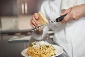 Grating parmesan onto spaghetti