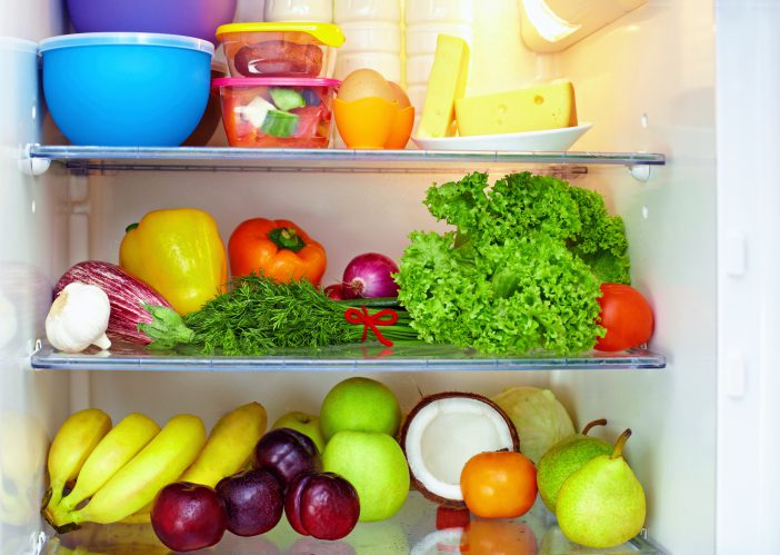 refrigerator full of healthy food. fruits and vegetables
