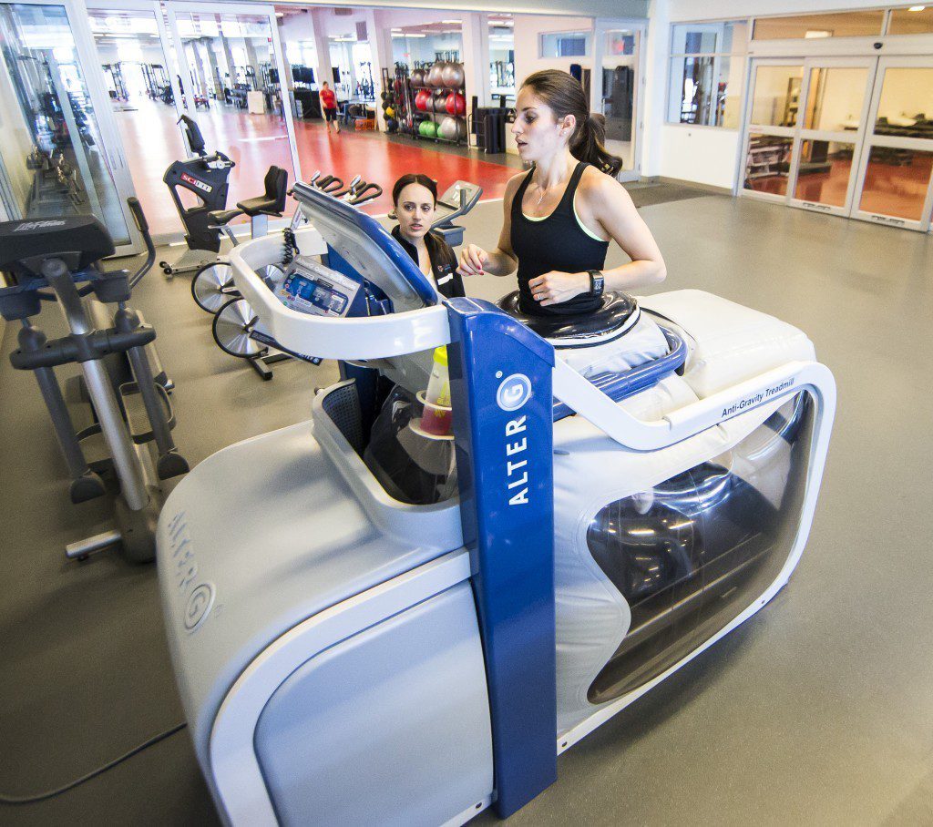 Physiotherapist Jenny Delich works with track athlete Natasha Jackson-Miller on the anti-gravity treadmill at the Canadian Sport Institute Calgary facilities on April 7, 2015.