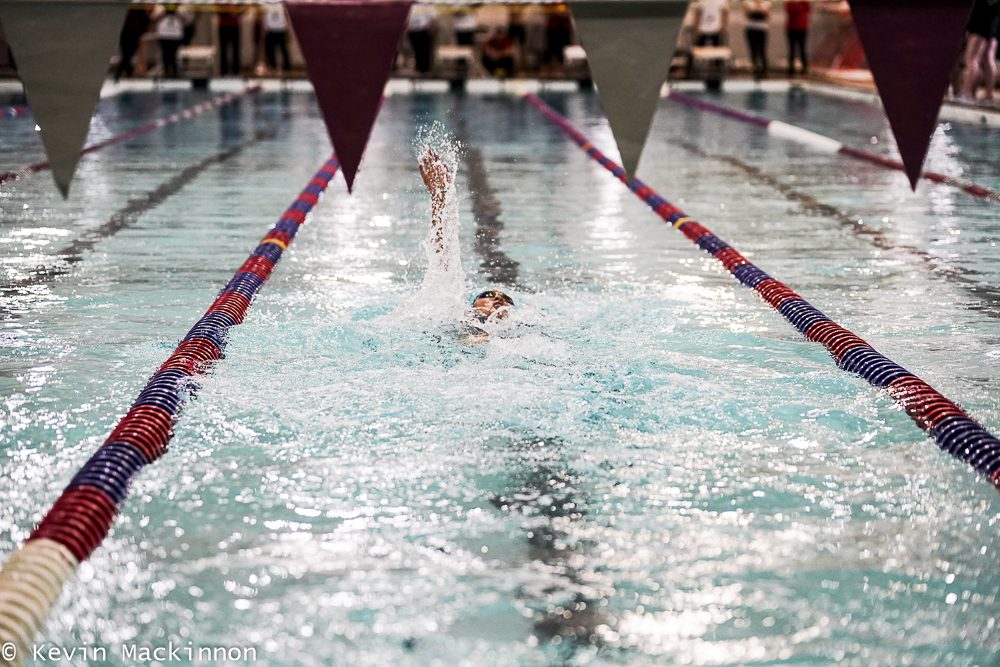 Swimmer competes at a swim meet.